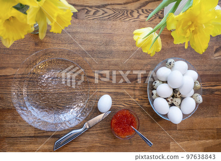 Top view of a bowl of boiled eggs and red caviar on wooden table, heathy breakfast meal Top view of a bowl of boiled eggs and red caviar on wooden table, heathy breakfast meal 97638843