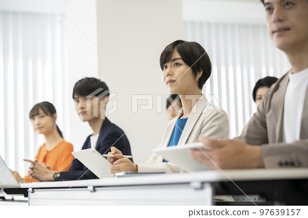 Young men and women receiving a seminar 97639157