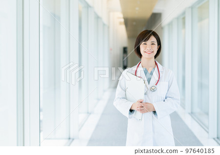 Female doctor walking in the corridor 97640185