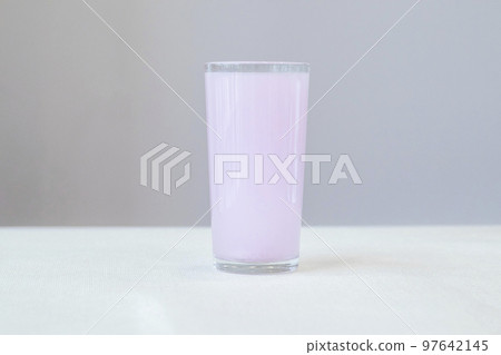 Glass with pink electrolytes dissolved in water for and during sports 97642145