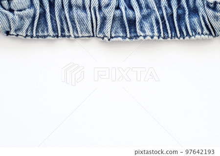 White background with blue denim on top as a frame. Flat lay, top view, copy space. Design for text. Directly Above View. 97642193