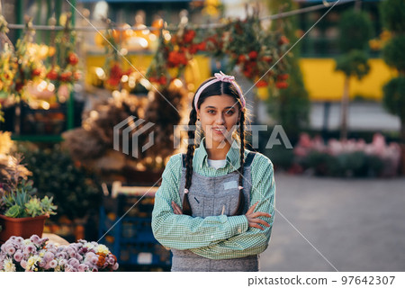 Happy farmer woman in denim overalls smiling sincerely while posing. 97642307