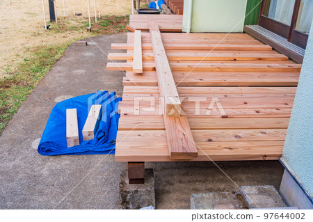 Residential wooden deck renovation (recovery) work scene 97644002