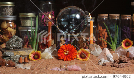Crystal Ball With Candles and Chakra Stones on Australian Red Sand 97644902