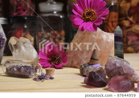 Amethyst Crystals With Flowers and Incense Cone on Meditation Table 97644959