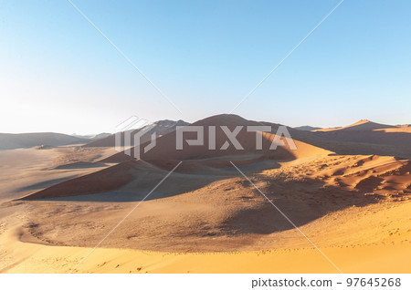 Climbing Dune 45 at sunrise 97645268