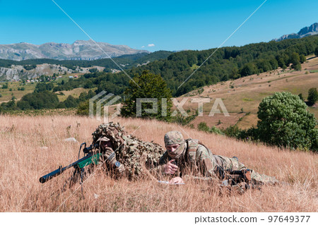 Army soldier holding sniper rifle with scope and aiming in forest. War, army, technology and people concept 97649377