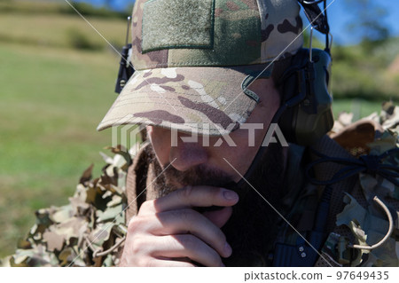 Special operations soldiers team preparing tactical and communication gear for action battle. Long distance sniper team in checking gear for action 97649435