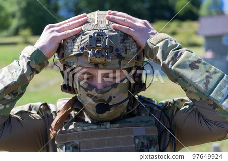 Special operations soldiers team preparing tactical and communication gear for action battle. Long distance sniper team in checking gear for action 97649924