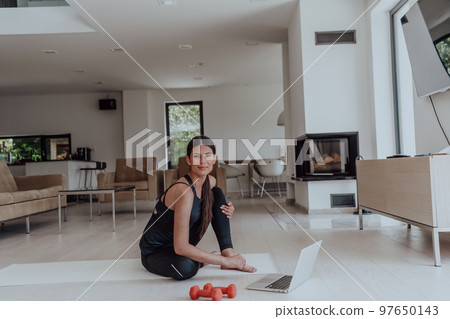 Young Beautiful Female Woman with Trainer via Video Call Conference in Bright Sunny House. Healthy Lifestyle, Wellbeing and Mindfulness Concept. 97650143