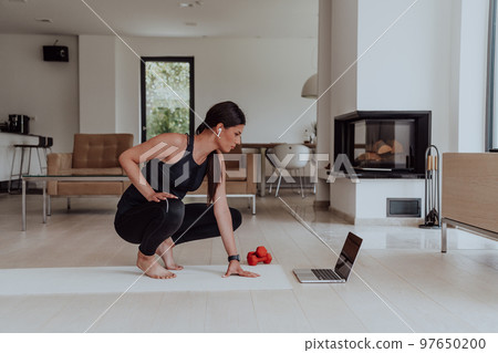 Young Beautiful Female Woman with Trainer via Video Call Conference in Bright Sunny House. Healthy Lifestyle, Wellbeing and Mindfulness Concept. 97650200