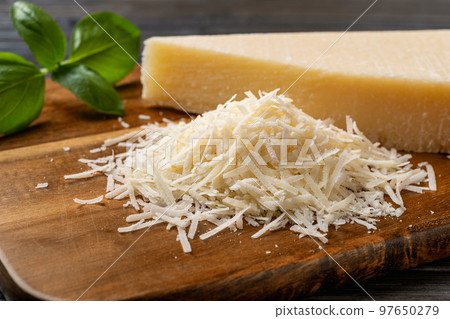 Heap of grated grana padano cheese closeup. Heap of grated grana padano cheese closeup. 97650279