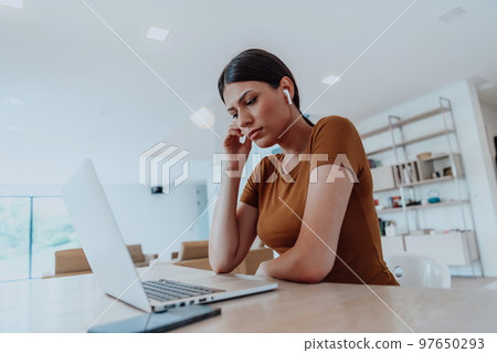 Woman sitting in living room using laptop look at cam talk by video call with business friend relatives, head shot. Job interview answering questions. Woman sitting in living room using laptop look at cam talk by video call with business friend relatives, head shot. Job interview answering questions. 97650293