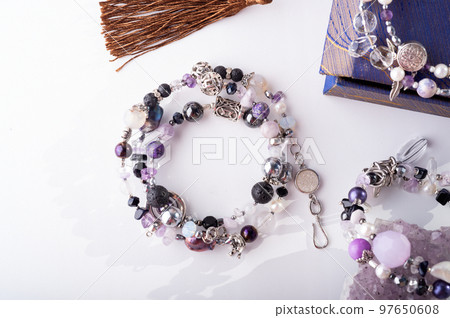 stylish jewelry bracelets with semiprecious and amethyst crystal at white background. hobby and fashion concept. close up stylish jewelry bracelets with semiprecious and amethyst crystal at white background. hobby and fashion concept. close up 97650608