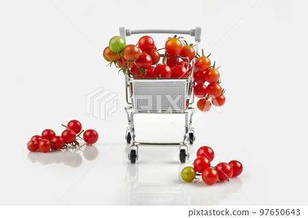 Mini shopping cart full with cherry tomatos on white background Mini shopping cart full with cherry tomatos on white background 97650643