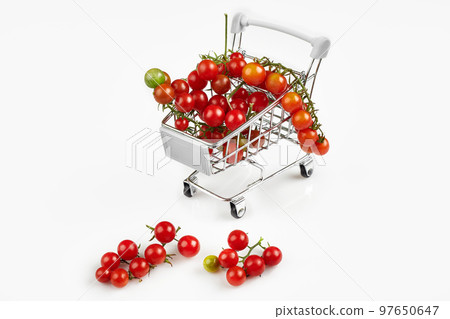 Mini shopping cart full with cherry tomatos on white background Mini shopping cart full with cherry tomatos on white background 97650647