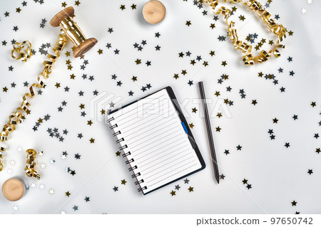 Flat Lay Christmas or Party Background with colored ribbons, decorations, confetti, and wrapping paper. Notepad for Text in Middle. Flat Lay Christmas or Party Background with colored ribbons, decorations, confetti, and wrapping paper. Notepad for Text in Middle. 97650742