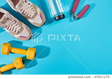 Female sport shoes and equipment top view, copy space. Active lifestyle, body care concept. Female sport shoes and equipment top view, copy space. Active lifestyle, body care concept. 97651179