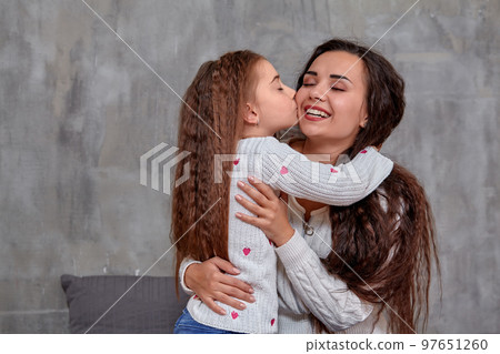 Eemotions of a beautiful young mother and her little daughter who spend time together 97651260
