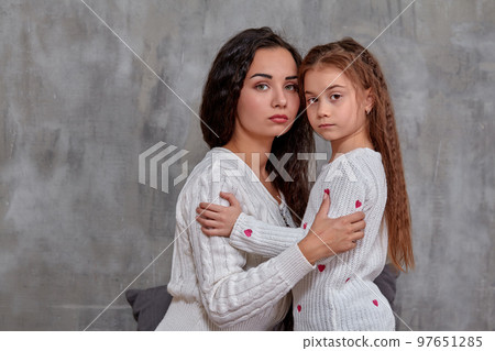 Eemotions of a beautiful young mother and her little daughter who spend time together Eemotions of a beautiful young mother and her little daughter who spend time together 97651285