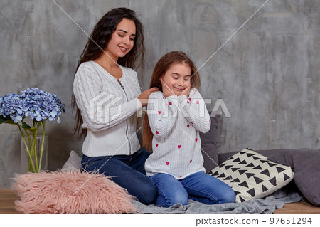 Eemotions of a beautiful young mother and her little daughter who spend time together 97651294