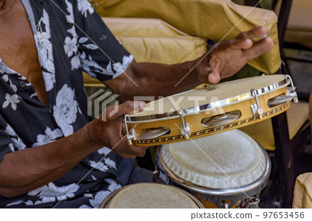 Detail of musician playing tambourine in the streets of Pelourinho in Salvador Detail of musician playing tambourine in the streets of Pelourinho in Salvador 97653456