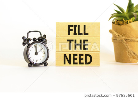 Fill the need symbol. Concept words Fill the need on wooden blocks on a beautiful white table white background. Black alarm clock. Business, finacial and fill the need concept. Copy space. 97653601