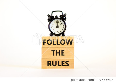 Follow the rules symbol. Concept words Follow the rules on wooden blocks. Beautiful white background. Black alarm clock. Business and follow the rules concept. Copy space. Follow the rules symbol. Concept words Follow the rules on wooden blocks. Beautiful white background. Black alarm clock. Business and follow the rules concept. Copy space. 97653602