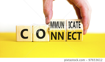 Connnect or communicate symbol. Concept word Connnect or Communicate on wooden cubes. Beautiful yellow table white background. Businessman hand. Business connnect communicate concept. Copy space. Connnect or communicate symbol. Concept word Connnect or Communicate on wooden cubes. Beautiful yellow table white background. Businessman hand. Business connnect communicate concept. Copy space. 97653612