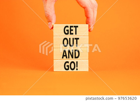 Motivational get out and do symbol. Concept words Get out and do on wooden cubes. Beautiful orange table orange background. Businessman hand. Business motivational get out and do concept. Copy space. Motivational get out and do symbol. Concept words Get out and do on wooden cubes. Beautiful orange table orange background. Businessman hand. Business motivational get out and do concept. Copy space. 97653620