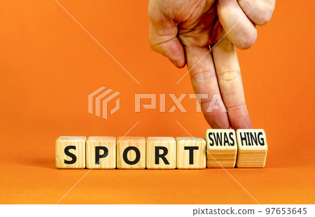 Sport or sportswashing symbol. Concept words Sport and Sportswashing on wooden cubes. Businessman hand. Beautiful orange table orange background. Business sport sportswashing concept. Copy space. Sport or sportswashing symbol. Concept words Sport and Sportswashing on wooden cubes. Businessman hand. Beautiful orange table orange background. Business sport sportswashing concept. Copy space. 97653645