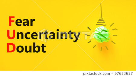 FUD fear uncertainty doubt symbol. Concept words FUD fear uncertainty doubt on yellow paper on a beautiful yellow background. Light bulb icon. Business FUD fear uncertainty doubt concept. Copy space. 97653657