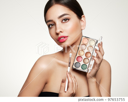 Beauty woman with eye shadow makeup palette Beauty woman with eye shadow makeup palette 97653755