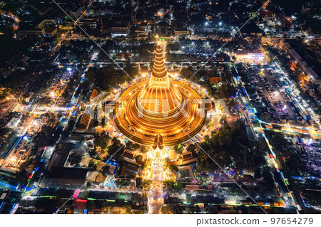 Majestic golden pagoda of Phra Pathom Chedi glowing among the festival lights around the roundabout road in downtown at Nakhon Pathom 97654279