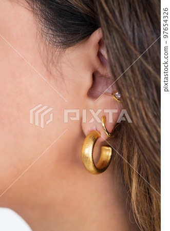 Bold Golden Hoop and other earrings on a woman's ear.  Beautiful valentine's gift. 97654326
