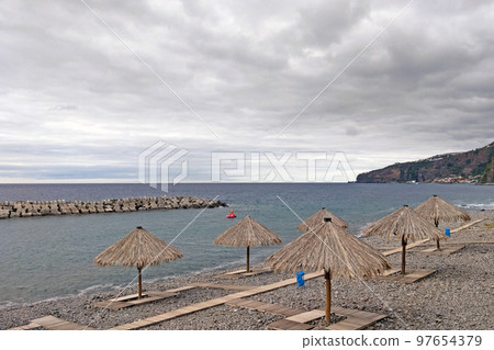 An empty beach by the sea or ocean. Not the season for rest, bad weather. An empty beach by the sea or ocean. Not the season for rest, bad weather. 97654379