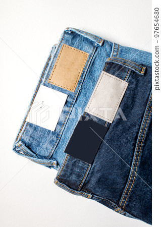 Two pairs of denim trousers with an empty leather label . Two pairs of denim trousers with an empty leather label . 97654680