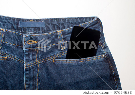 A modern phone in a jeans pocket displaying the app on a black screen. A modern phone in a jeans pocket displaying the app on a black screen. 97654688