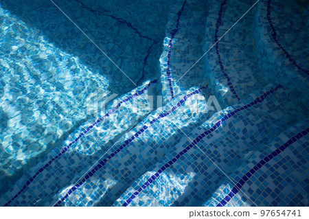 Stairs of the swimming pool in sunlight under water. Design of the swimming pool.  97654741