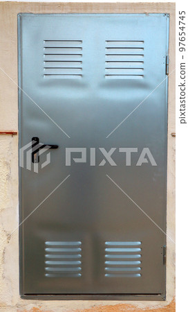 Metal door in gray steel color made of aluminum close-up, the door closes the counters in the wall 97654745