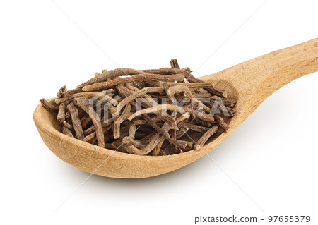 Dried Valerian root in wooden spoon isolated on white background. Valeriana officinalis with full depth of field. 97655379