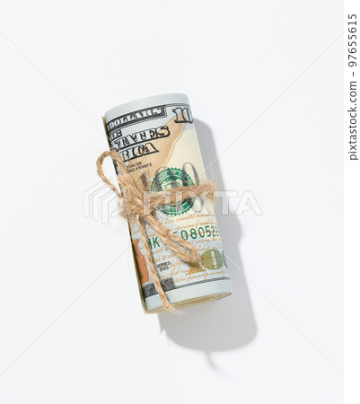 Rope tied roll of one hundred dollar bills isolated on white background Rope tied roll of one hundred dollar bills isolated on white background 97655615