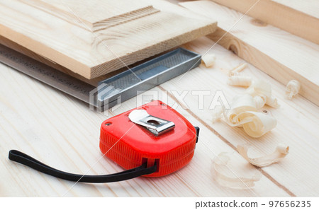 A measuring tape and a square. 97656235