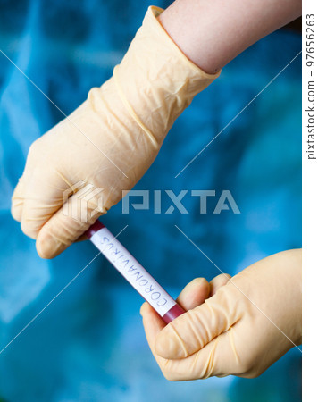 Hands holding blood test result for Coronavirus Hands holding blood test result for Coronavirus 97656263