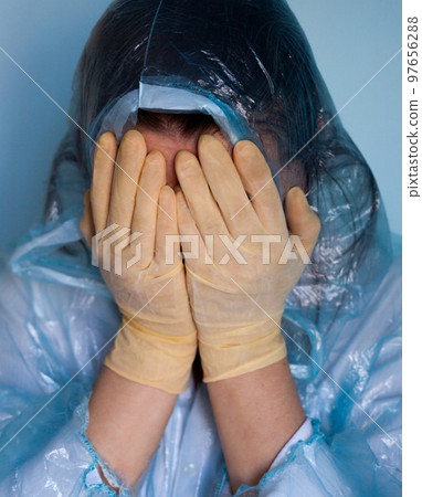 Woman in a protective suit closing her face. Woman in a protective suit closing her face. 97656288