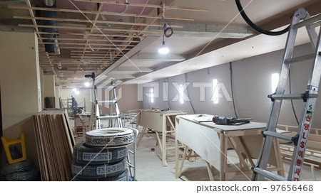 Indoor golf course construction. Interior. People. Structure. Wall. Wood. Carpentry Indoor golf course construction. Interior. People. Structure. Wall. Wood. Carpentry 97656468