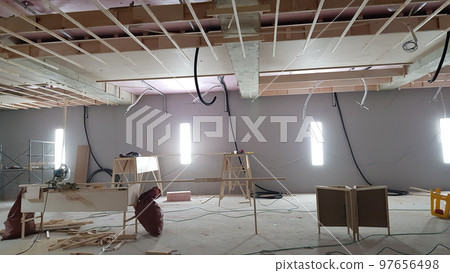 Indoor golf course construction. Interior. People. Structure. Wall. Wood. Carpentry Indoor golf course construction. Interior. People. Structure. Wall. Wood. Carpentry 97656498