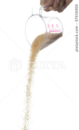 Brown Sugar fall, brown grain sugar pouring down abstract cloud fly from measuring cup. Beautiful complete seed sugarcane, food object design. Selective focus freeze shot white background isolated Brown Sugar fall, brown grain sugar pouring down abstract cloud fly from measuring cup. Beautiful complete seed sugarcane, food object design. Selective focus freeze shot white background isolated 97656900
