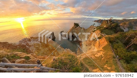Koganezaki Uma Rock, shining in the setting sun, panorama shot Koganezaki Uma Rock, shining in the setting sun, panorama shot 97658942