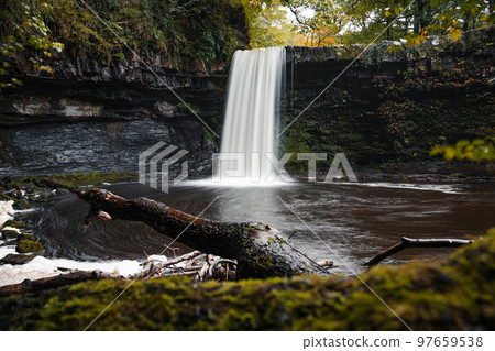 Sgwd Gwladys waterfall or Lady Falls in Brecon Beacons National Park, the Vale of Neath. South Wales, the United Kingdom. Four Waterfalls walk. Long exposure. Sgwd Gwladys waterfall or Lady Falls in Brecon Beacons National Park, the Vale of Neath. South Wales, the United Kingdom. Four Waterfalls walk. Long exposure. 97659538